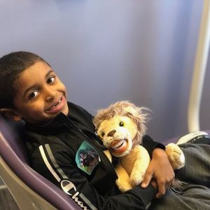 boy smiling with stuffed lion