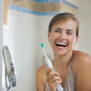 Women Smiling with a tooth brush 
