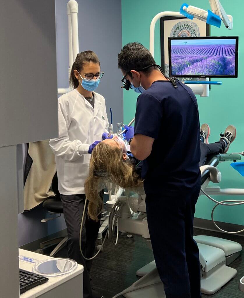 Dentist and assistant working on a patient