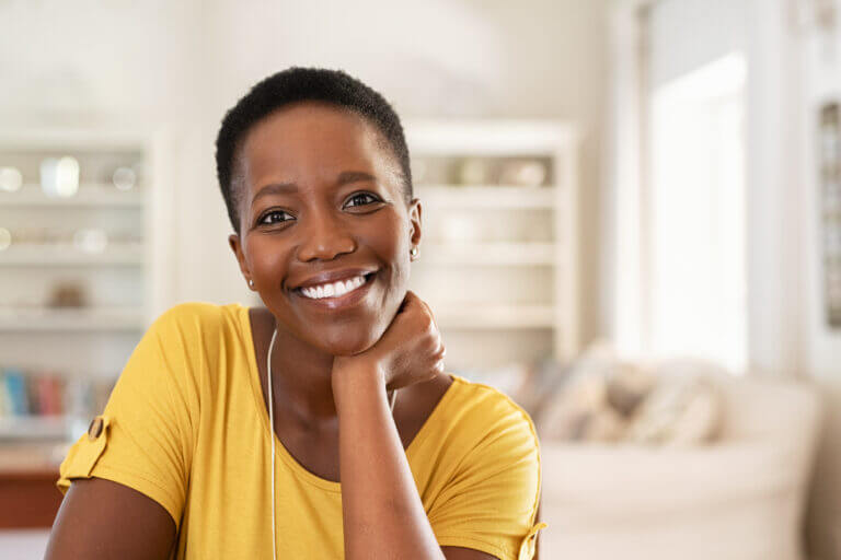 Portrait of mature woman sitting at home and looking at camera. C